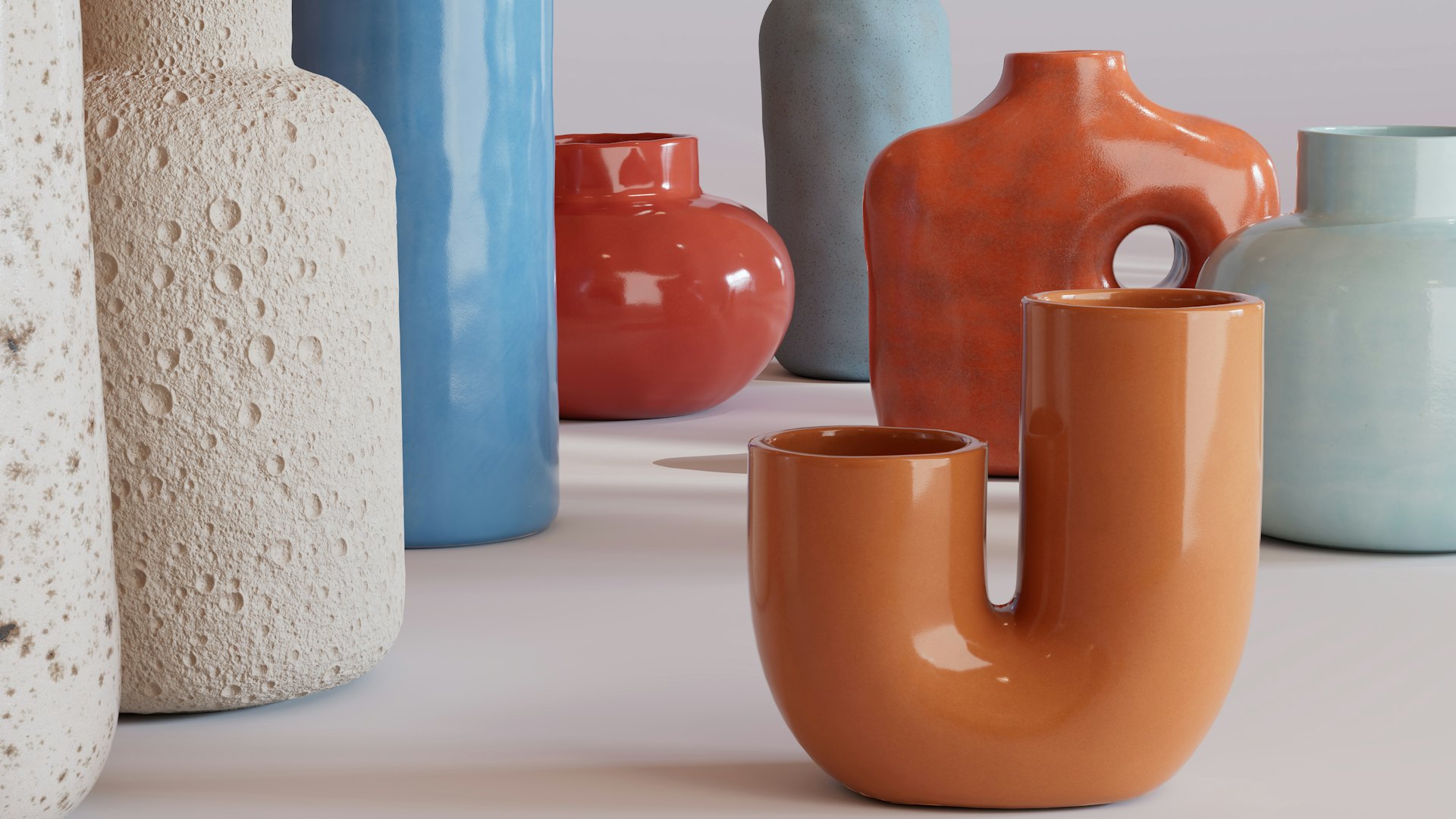 Terracotta and sky-blue vases on a pale table